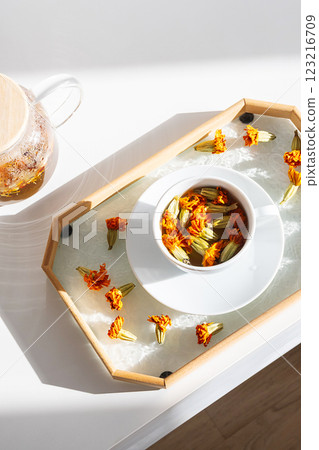 Blooming Marigold Tea Ritual. Natural Wellness Concept. Blooming Marigold Tea Ritual. Natural Wellness Concept. 123216709