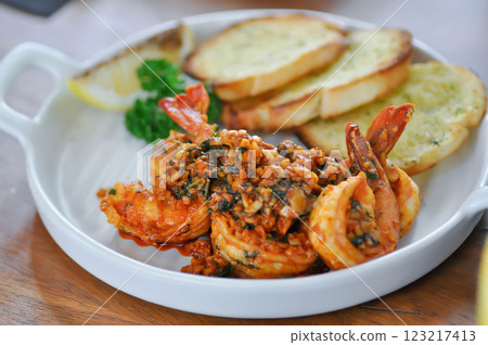 stir fried shrimp or Gambas al Ajillo or Shrimps pan fried with extravirgin olive oil and garlic with toast or bread stir fried shrimp or Gambas al Ajillo or Shrimps pan fried with extravirgin olive oil and garlic with toast or bread 123217413