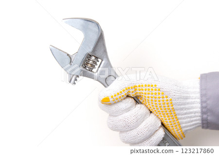 Worker with a monkey wrench 123217860