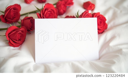Postcard mock up on white bed surrounded red roses. Gift certificate mock up. Valentine's day 123220484