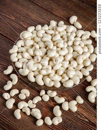 Cashew nuts in milk chocolate on a brown wooden background. 123223838