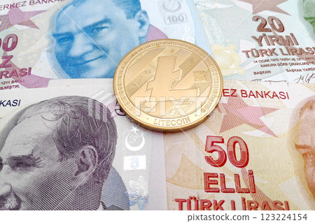 Litecoin coin on top of a stack of Turkish liras Litecoin coin on top of a stack of Turkish liras 123224154