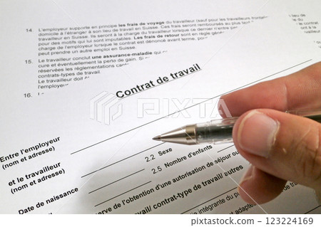 Man filling out a Swiss employment contract form 123224169
