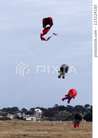 Superhero-like kites flying in mid-air Superhero-like kites flying in mid-air 123224185