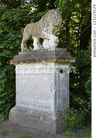Sculpture of a lion with his paw placed on a sphere in Chantilly Sculpture of a lion with his paw placed on a sphere in Chantilly 123224229