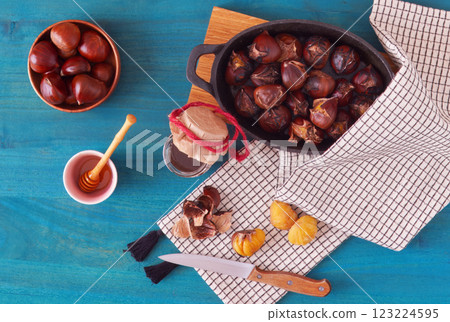 Edible chestnuts, honey, symbols of the fall. Edible chestnuts, honey, symbols of the fall. 123224595