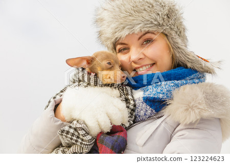 Woman hug warming her dog in cold day Woman hug warming her dog in cold day 123224623