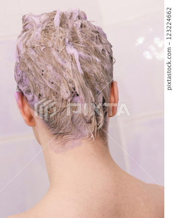 Woman under the shower with colored foam on hair 123224662