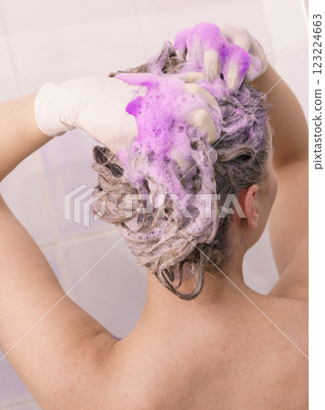 Woman under the shower with colored foam on hair 123224663
