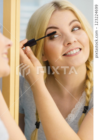 Woman using mascara on her eyelashes 123224699