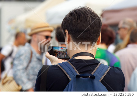 Unrecognized person taking photos of a marketplace on the street in Prague. Unrecognized person taking photos of a marketplace on the street in Prague. 123225190