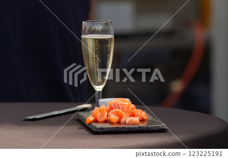 Fresh raw salmon with glass of wine at the street food market. Fresh raw salmon with glass of wine at the street food market. 123225191