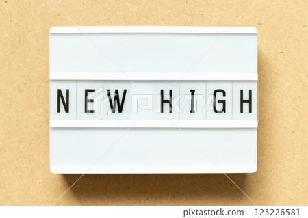 Lightbox with word new high on wood background 123226581