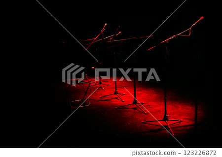 Microphone stand illuminated by red lights (music stage) Microphone stand illuminated by red lights (music stage) 123226872