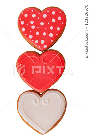 Three gingerbread cookies in the shape of hearts in red, white and red polka dots isolated. Three gingerbread cookies in the shape of hearts in red, white and red polka dots isolated. 123226970