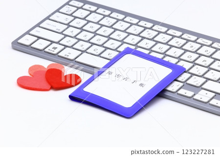 Image of a computer and a disability certificate 123227281