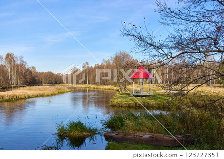 Autumn Day River Scene with Red Gazebo and Old Boat Autumn Day River Scene with Red Gazebo and Old Boat 123227351