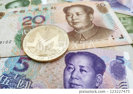 Monero coin on a stack of Chinese Yuan 123227475