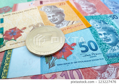 Dash coin on a stack of Malaysian Ringgit 123227476