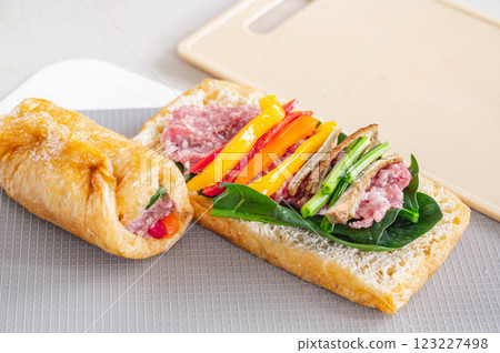Place vegetables and minced meat on the halved Tochioage. Place vegetables and minced meat on the halved Tochioage. 123227498