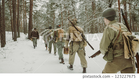 American Infantry Soldier Going Through Forest Road In Cold Winter Day. Usa Soldier Marching By Country Road. Usa Army Soldiers Of World War Ii. Heroes Of War 123227675