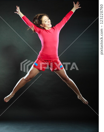 Happy young woman jumping for joy. 123228760