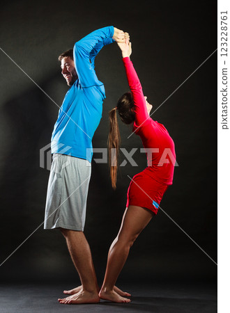 Happy fit sporty couple woman and man stretching. Happy fit sporty couple woman and man stretching. 123228761