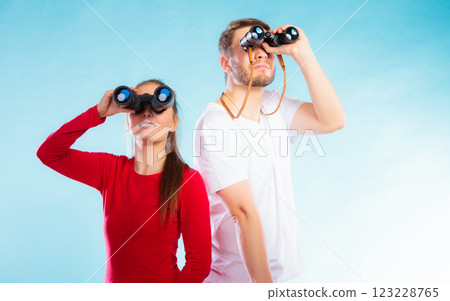Couple looking through binoculars 123228765