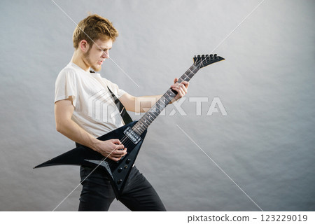 Man playing on electric guitar Man playing on electric guitar 123229019