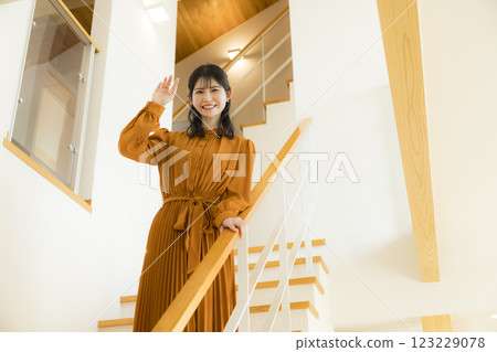 Young woman going down the stairs 123229078