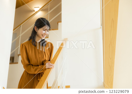 Young woman going down the stairs 123229079
