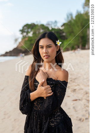 Beautiful young Asian woman during summer beach holiday Beautiful young Asian woman during summer beach holiday 123230010
