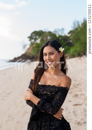 Beautiful young Asian woman during summer beach holiday Beautiful young Asian woman during summer beach holiday 123230011