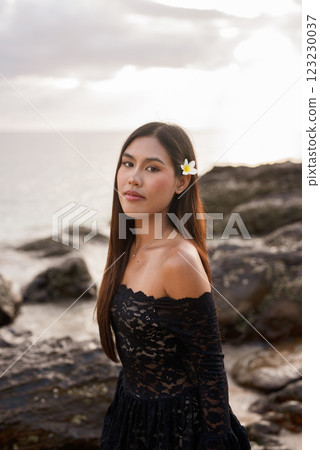 Beautiful young Asian woman during summer beach holiday 123230037