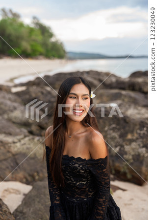 Beautiful young Asian woman during summer beach holiday Beautiful young Asian woman during summer beach holiday 123230049