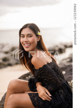 Beautiful young Asian woman during summer beach holiday 123230062