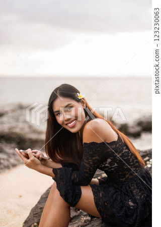 Beautiful young Asian woman during summer beach holiday 123230063