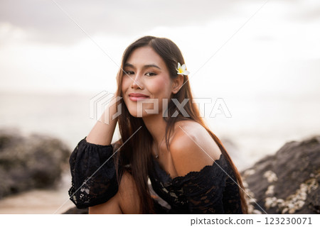 Beautiful young Asian woman during summer beach holiday 123230071