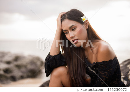 Beautiful young Asian woman during summer beach holiday 123230072