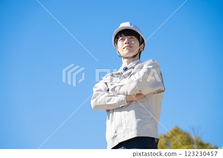 A man wearing work clothes A man wearing work clothes 123230457