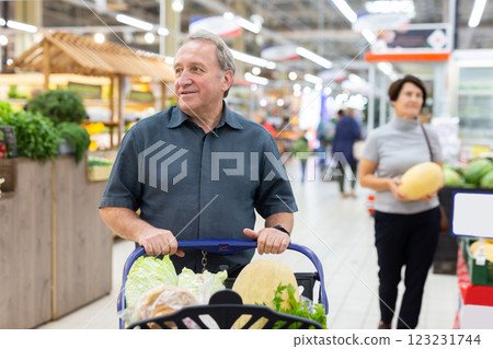 Elderly man with shopping cart shopping in supermarket 123231744