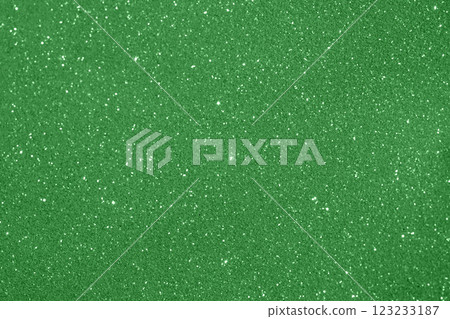 Bright green glitter textured surface with scattered white sparkling flecks 123233187
