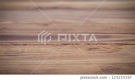 Close-up of a rustic wooden table with a blurred natural background 123233197