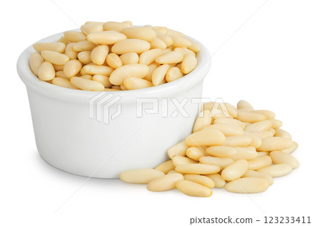 Shelled European pine nuts in ceramic bowl isolated on white background with full depth of field 123233411