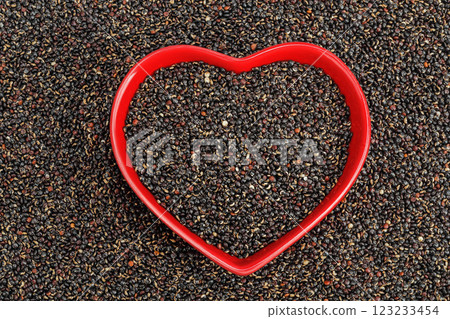 black quinoa in ceramic bowl as a background. Top view. Flat lay 123233454