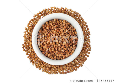 Raw buckwheat in ceramic bowl isolated on white background. Top view. Flat lay Raw buckwheat in ceramic bowl isolated on white background. Top view. Flat lay 123233457