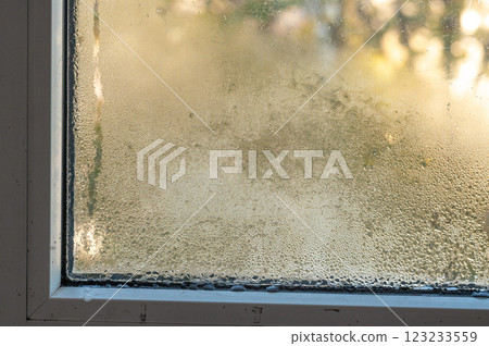 drops of water run down the windowpane. condensate 123233559