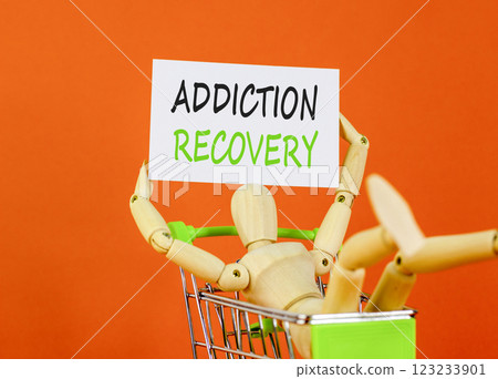 Addiction recovery symbol. Concept words Addiction recovery on beautiful white card. Psychologist model. Beautiful orange background. Psychology addiction recovery concept. Copy space. 123233901