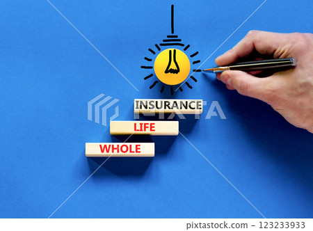 Whole life insurance symbol. Concept words Whole life insurance on beautiful wooden blocks. Beautiful blue table blue background. Businessman hand. Business whole life insurance concept. Copy space. 123233933