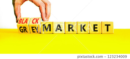 Black or grey market symbol. Concept words Black market or Grey market on beautiful wooden blocks. Beautiful white background. Businessman hand. Business black or grey market concept. Copy space. 123234009